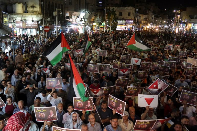 Demonstrators carry Palestinian flags and signs during a protest in support of Palestinians in Gaza, amid the ongoing conflict between Israel and Hamas, in Amman, Jordan, September 13, 2024. REUTERS/Jehad Shelbak