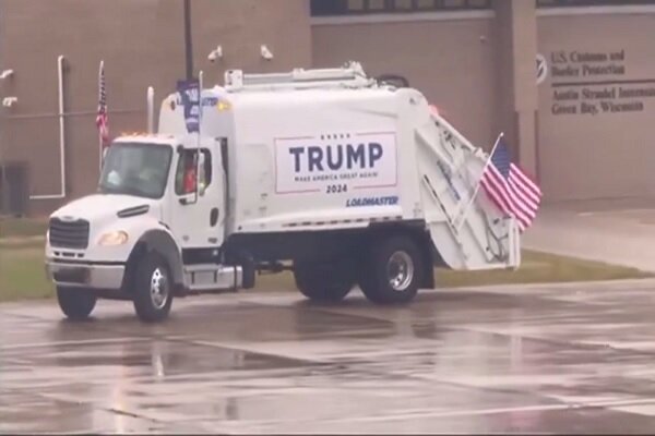 “Trump” riding a garbage truck + video